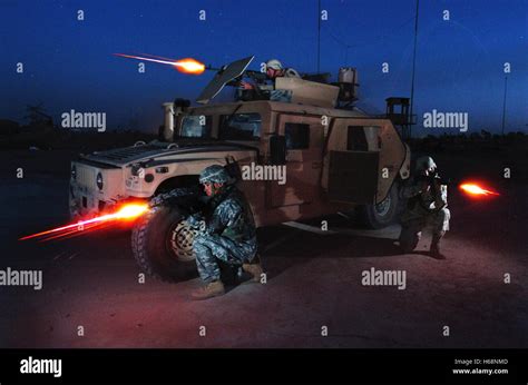 U.S. Army soldiers participate in a nighttime live fire training exercise at the Iraqi Army ...