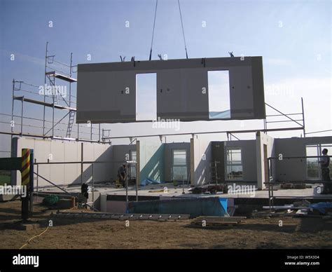 crane lifting a part of a prefab house Stock Photo - Alamy