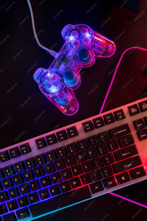 Free Photo | View of illuminated neon gaming keyboard setup and controller