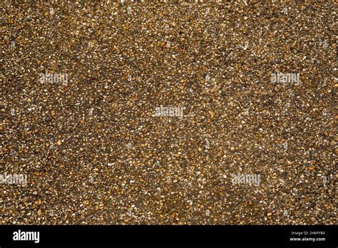 Pea shingle embedded on tar as a durable, non-slip path / road surface Stock Photo - Alamy