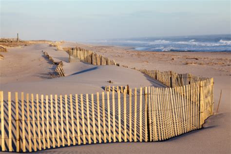 Beach Fence Sand And The Ocean Stock Photo - Download Image Now - iStock