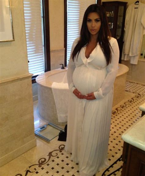 Pregnant Kim Kardashian cradles baby bump in baby shower picture - Celebrity News News - Reveal