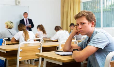 Sad Boy Sitting at Desk in School Class Stock Image - Image of student, lifestyle: 197752269