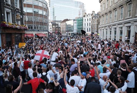 Jubilant England fans stop traffic in central London to sing 'Football's Coming Home'... despite ...