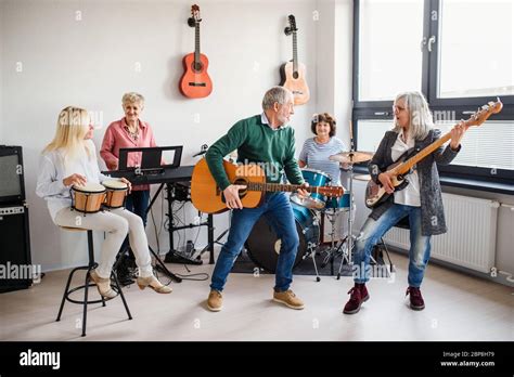 Group of senior people playing musical instruments indoors in band ...