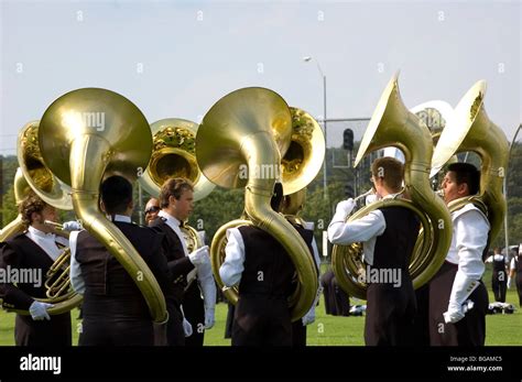 Tuba players from a marching band warming up before a football game half time Stock Photo - Alamy
