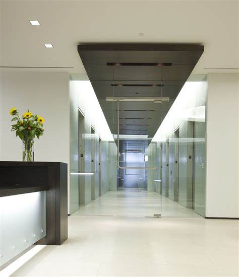 Modern Elevator Lobby Design with Dark Ceiling and Black Lobby Island ...