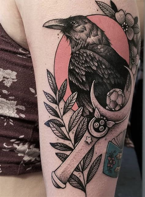 a black bird sitting on top of a wrench with flowers and leaves around it