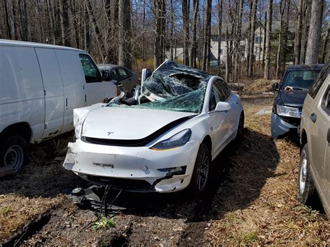 Tesla Model 3 crashes into semi trailer, driver survives roof being ...