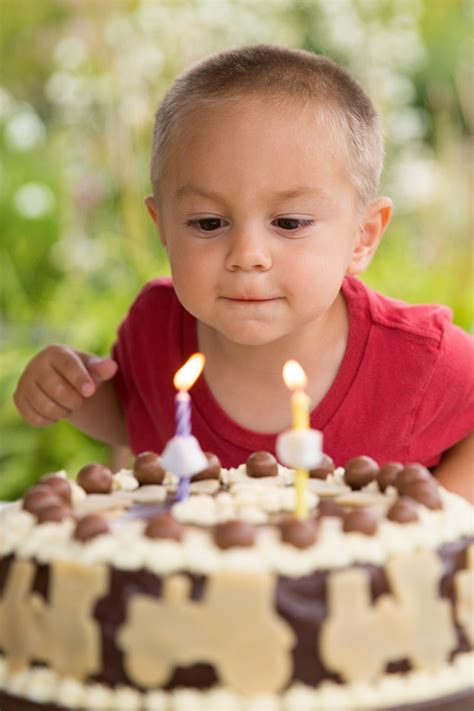 Boy Blowing Out Candles Free Stock Photo - Public Domain Pictures