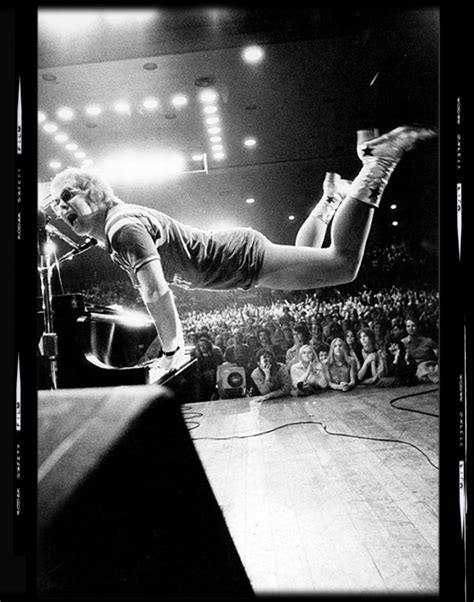 Elton John captured in mid air as he plays the piano, Los Angeles ...