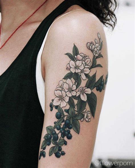 Apple blossoms and blueberries tattoo on the left upper arm | Apple blossom tattoos, Floral ...