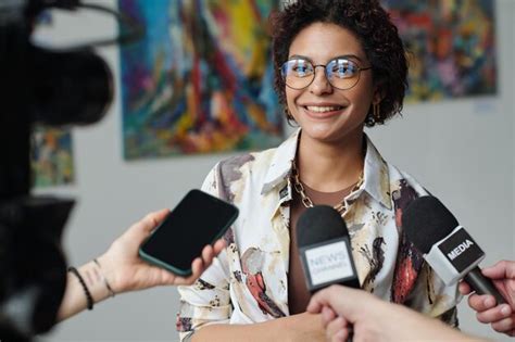 Premium Photo | Young artist giving an interview at her exhibition of art