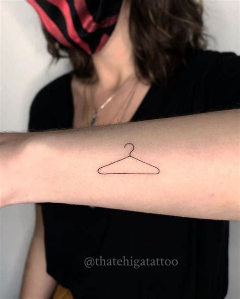 The Meaning Behind the Coat Hanger Tattoo: A Symbol of Strength and ...