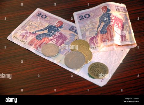 Tunisian currency, dinar banknotes and coins Stock Photo - Alamy