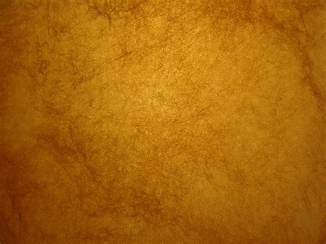 an orange background with some brown stains on the top and bottom part ...