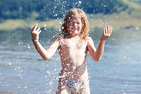 Beautiful little girl splashes in the water Stock Photo by ©evgeniyauvarova 11704498