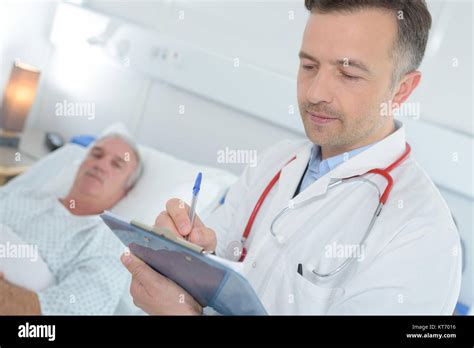 medical staff writing notes on patients condition Stock Photo - Alamy
