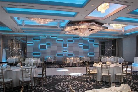 a banquet room set up with white tables and chairs