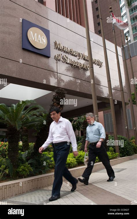 People walk past the the Monetary Authority of Singapore (MAS) building ...