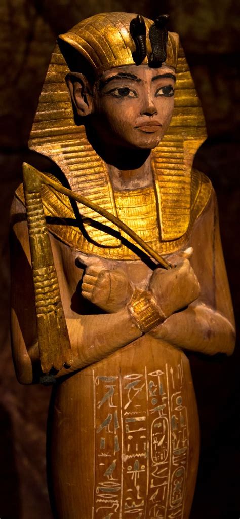 Ushabti of Tutankhamun. Image and description via Wiki: ”This is a partly gilded wooden ushabti ...