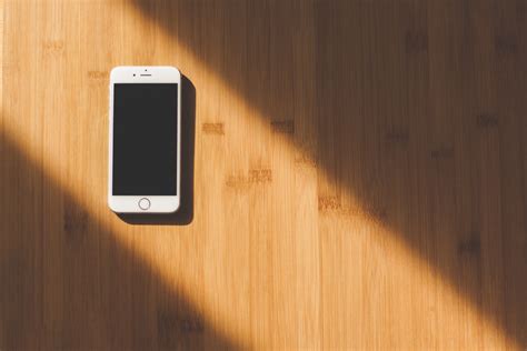 White Apple Iphone on Wooden Table · Free Stock Photo