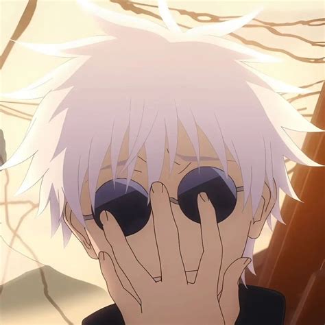 a man with white hair and sunglasses covering his face