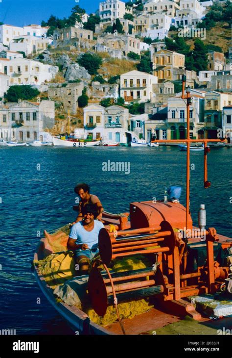 Fishing in Symi Harbour, Crete Stock Photo - Alamy