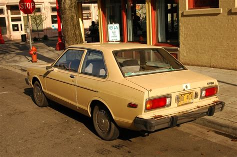 OLD PARKED CARS.: 1979 Datsun 210 Coupe.