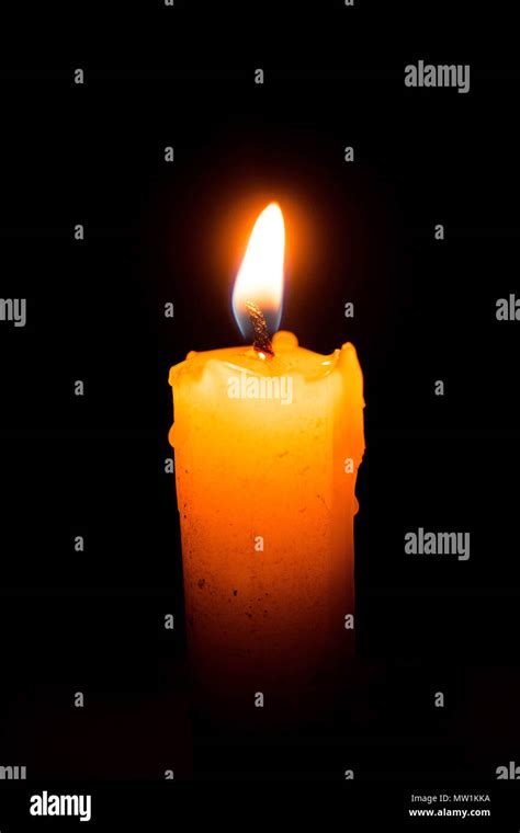 Single lit candle with quite flame Stock Photo - Alamy