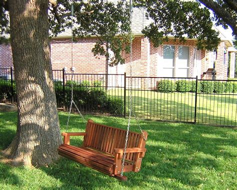 loveseat swing in a tree | Tree bench, Porch swing, Outdoor wooden swing