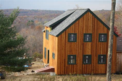 barn style home under construction with barn board siding | Vertical house siding, Wood siding ...