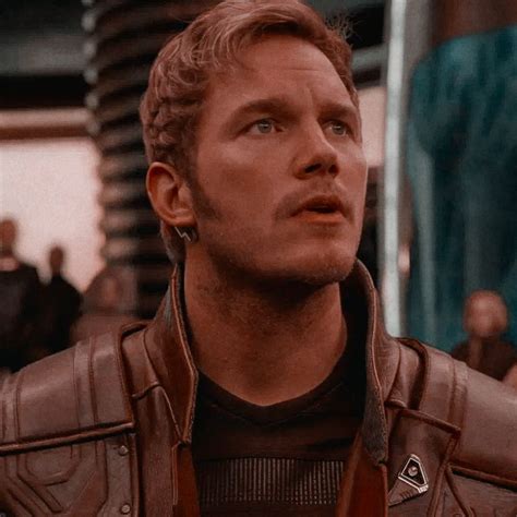 a close up of a person wearing a leather jacket and looking off to the side