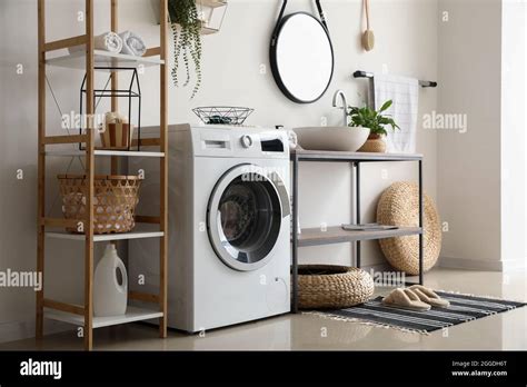 Interior of bathroom with modern washing machine Stock Photo - Alamy