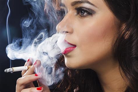 Indian Glamorous young beautiful Latin woman smoking cigarette smoke ...