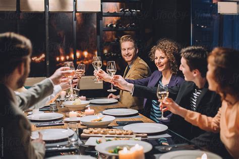 "Group Of Business People Toasting At Dinner Party" by Stocksy Contributor "Lumina" - Stocksy