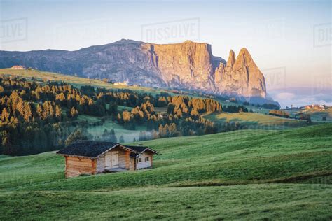 Alpe di Siusi or Seiser Alm, mountain path and Sciliar or Schlern mountain in sunrise light ...