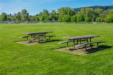 Picnic tables in public park featuring park, grass, and lawn | Nature Stock Photos ~ Creative Market