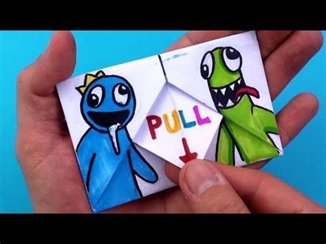 someone is holding up a paper origami that says pull and an image of two monsters