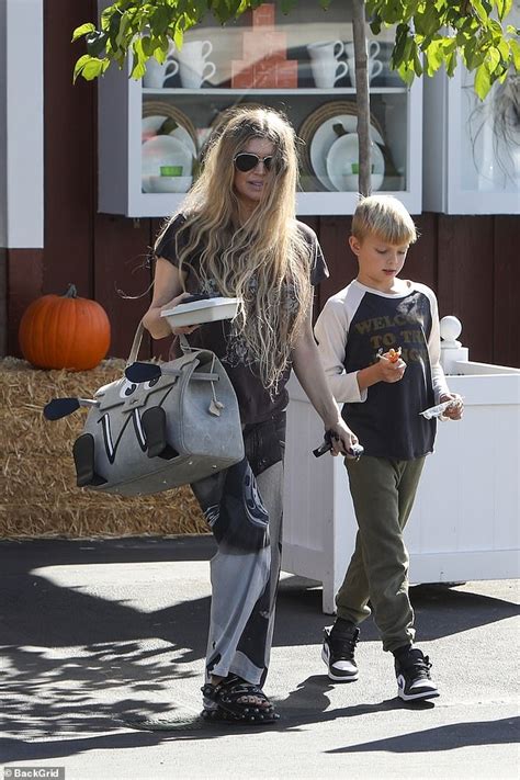 Fergie is ever the doting mother as she steps out with son Axl in matching Guns N' Roses T ...