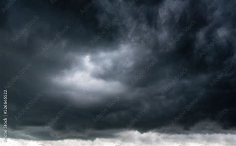 Dramatic dark storm rain clouds black sky background. Dark thunderstorm clouds rainny atmosphere ...