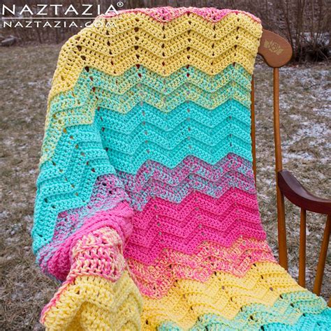 a crocheted blanket sitting on top of a wooden chair