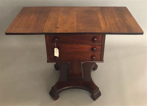 Semi antique drop leaf table with three drawers on square ba