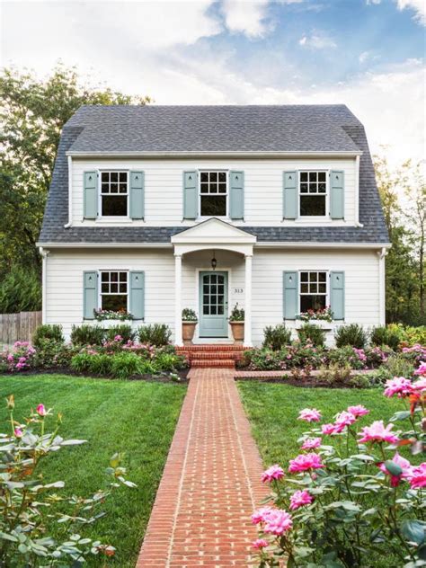 gray siding house with white shutters - Tanna Goforth