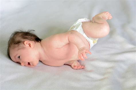 Rolling Over in Babies - When it Develops & How to Encourage - Being ...