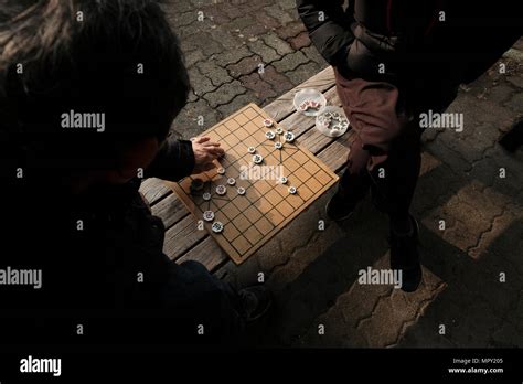 Korean men playing a strategy board game called Janggi changgi or jangki, sometimes called ...