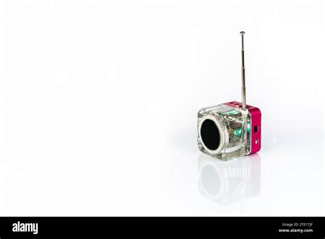 A small cube-shaped radio receiver on a white background with reflection Stock Photo - Alamy