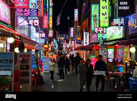 BUSAN, SOUTH KOREA - MARCH 27, 2023: People visit night streets of Bupyeon-dong in downtown ...