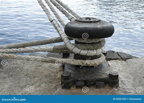 Mooring Bollard On A Background Of Blue Water Surface, Loaf Embankment, Cast-iron Chain Royalty ...