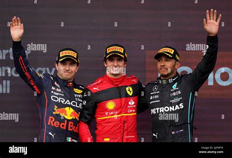 Race winner Carlos Sainz of Ferrari (centre) with Red Bull's Sergio ...